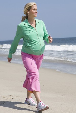 Pregnant woman walking outdoors.