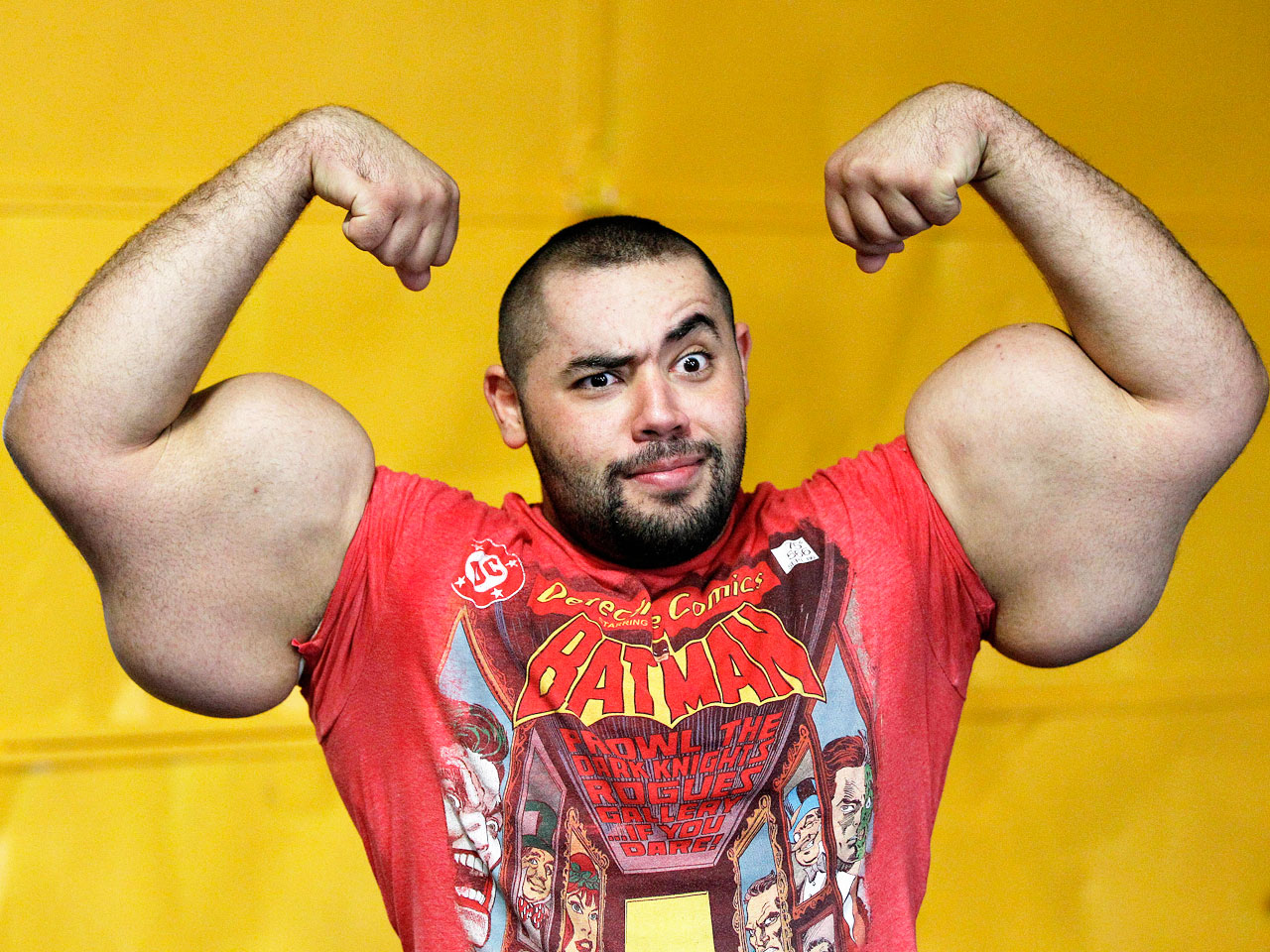 In this photo taken, Friday, Nov. 16, 2012, Egyptian Body builder Moustafa Ismail poses during his daily workout at World Gym in Milford, Mass. Ismail has been given the title of world's biggest arms, biceps and triceps, by the Guinness Book of World Records. (AP Photo/Stephan Savoia)
