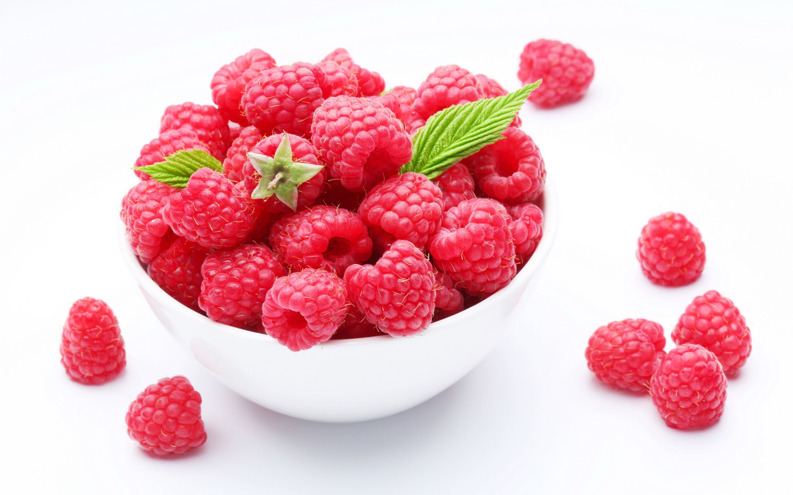 Crockery with  beautiful tempting raspberries. Isolated on white background.