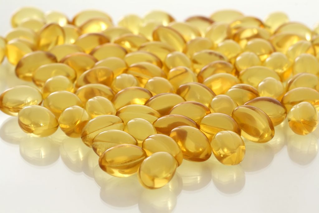 Fish oil capsules on a white background